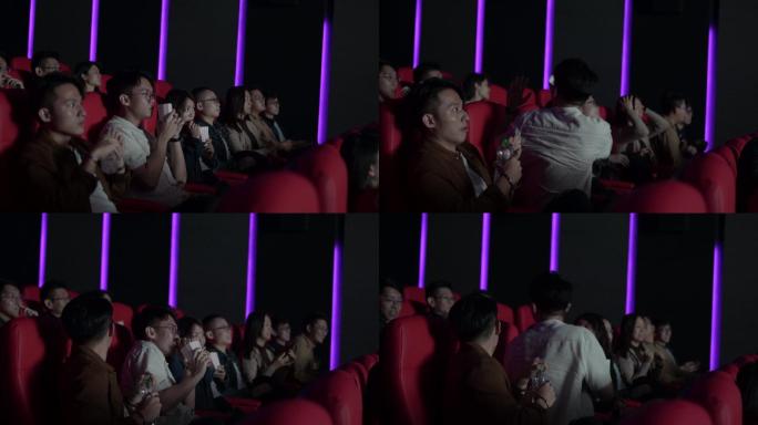 一名亚裔中国年轻男子不小心将爆米花向后倒给其他观众，惊悚电影场景让他大吃一惊