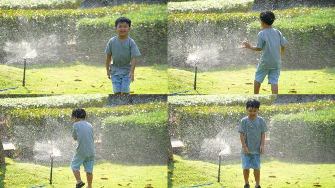 亚洲小孩在公园里玩泼水游戏。夏天和幸福的概念