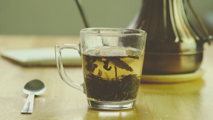 一杯茶悬浮的茶叶透明水杯