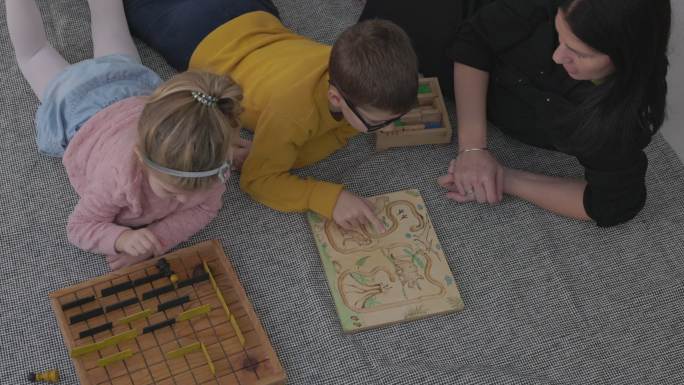 日托中心女教师与孩子玩棋盘游戏