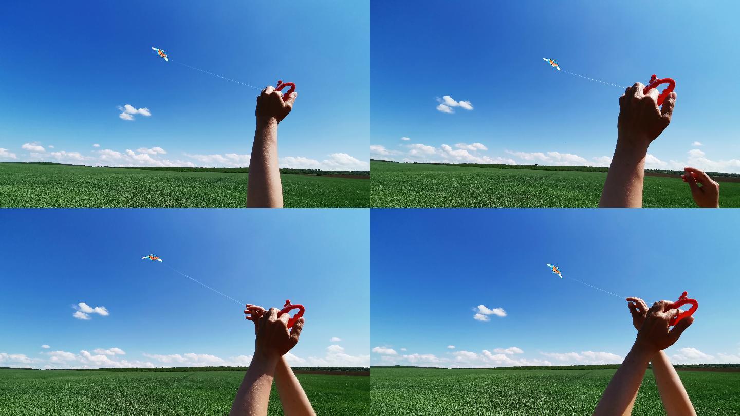 手放风筝在晴朗的蓝天下越过麦田，望去。童年的乐趣。