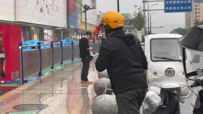 雨天外卖小哥快递员电瓶车送快餐送货