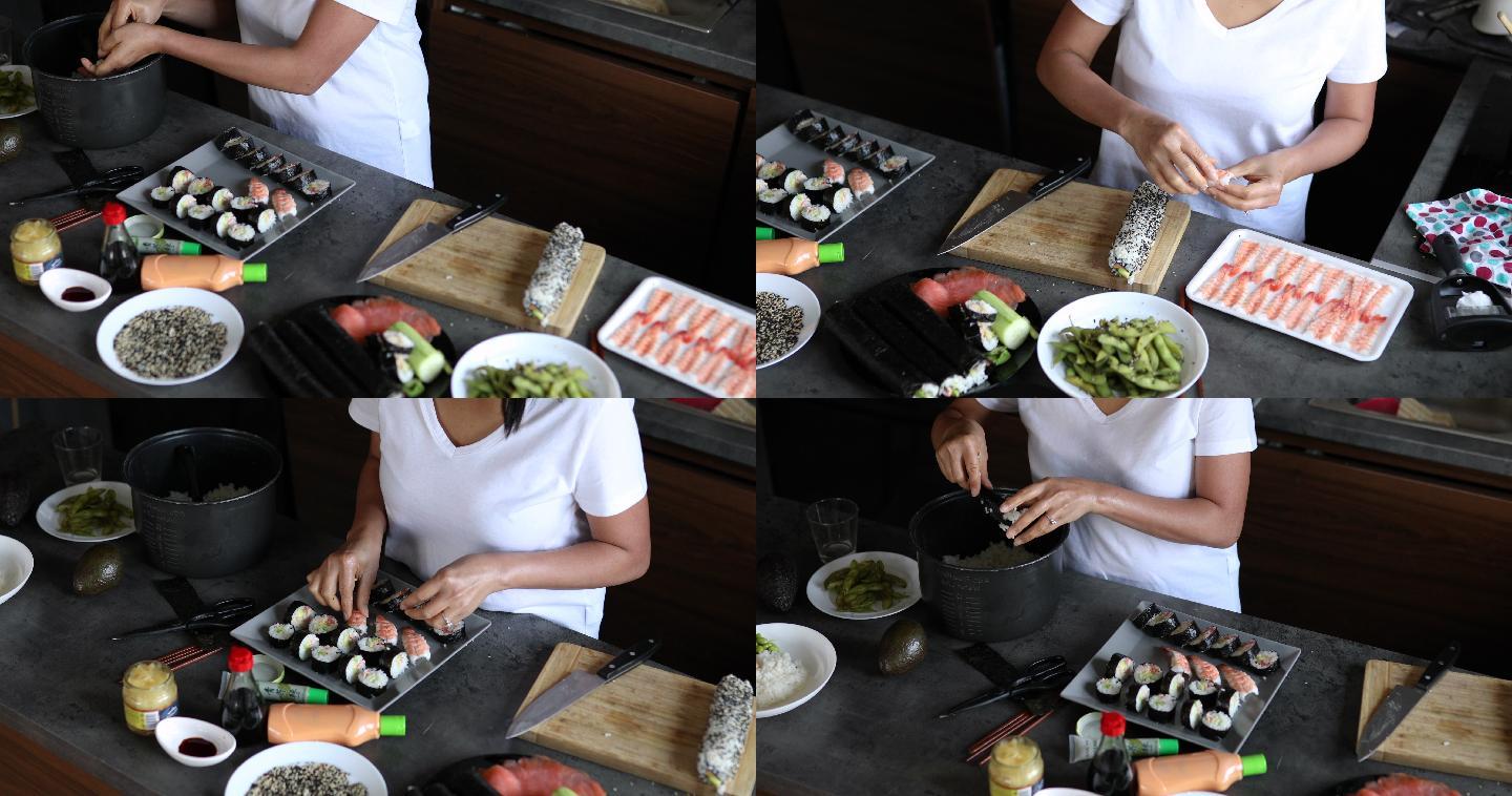 一名泰国妇女在做饭团，并在盘子上摆放Nigiri寿司卷