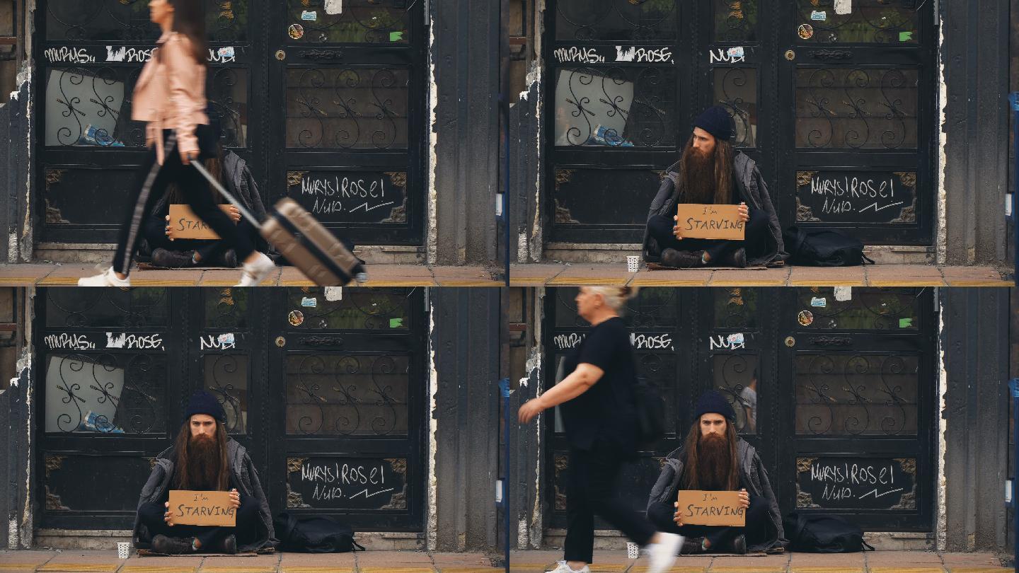 无家可归的人拿着“我饿死了”硬纸板在拥挤的街道上乞讨