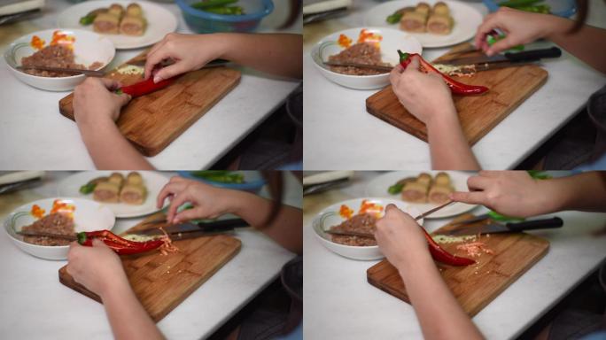 客厅里女人用菜刀切辣椒、手洗辣椒的高角度照片