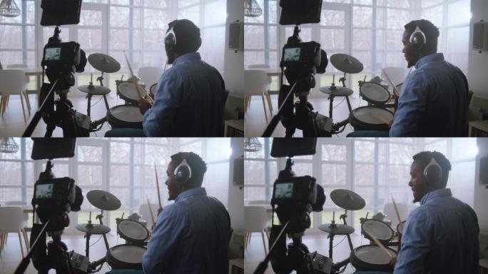 一名非洲裔男子在起居室练习电子鼓。录制音乐会话