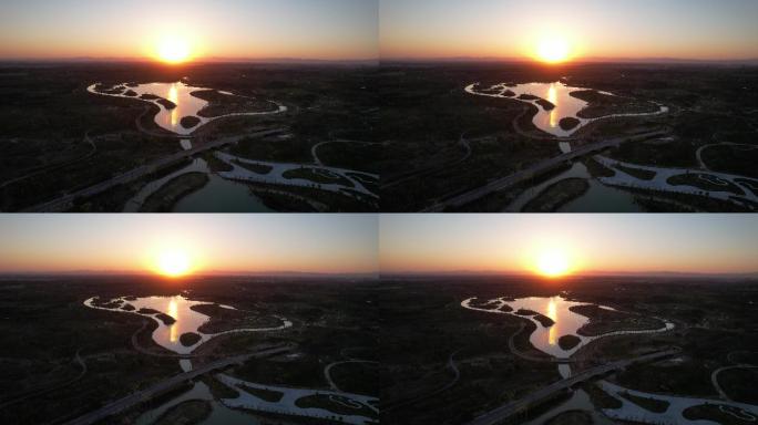 航拍中国雄安新区郊野公园夕阳与湖水