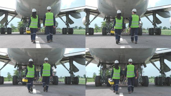 亚洲男女工程师维护飞机团队在机场对飞机前部进行维修、修理、现代化和翻新。