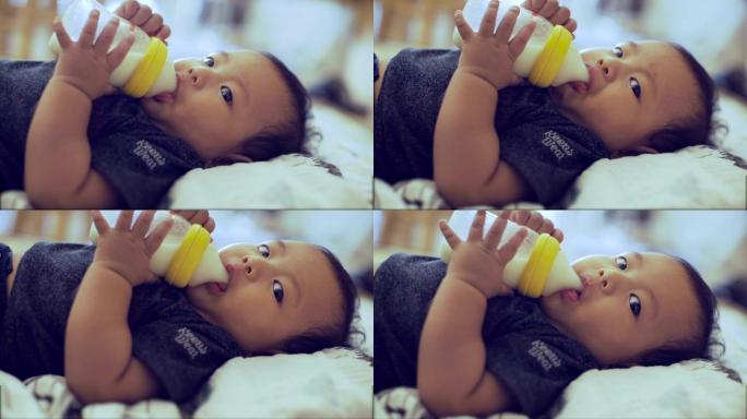 特写：婴儿用奶瓶吃食物
