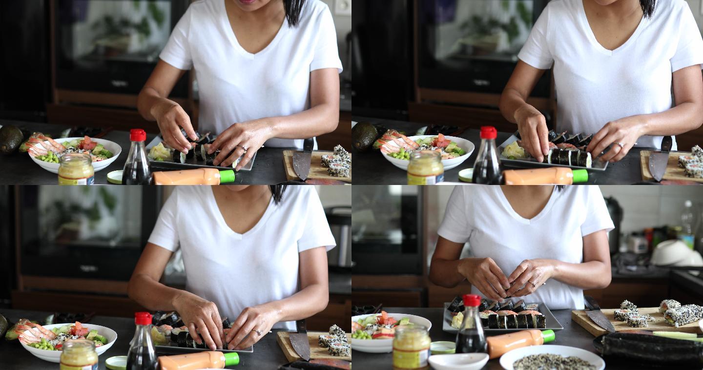 女寿司师傅用Nigiri寿司卷和传统寿司卷在盘子上排列由内而外的寿司卷