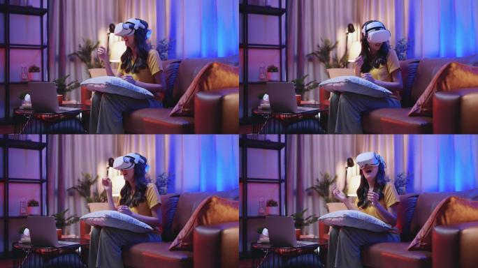 年轻迷人的休闲亚裔女性在家里的客厅里，通过VR眼镜、耳机、护目镜，在沙发上观看虚拟现实中的表演生活流