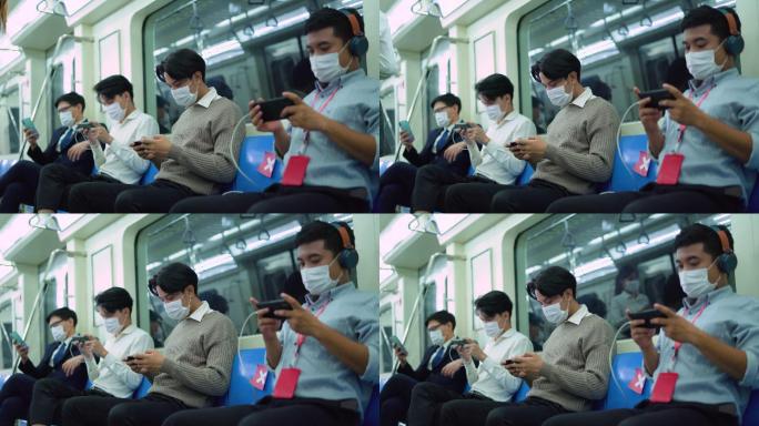 一名年轻男子坐在社交场所，一边用手机安全地乘坐地铁