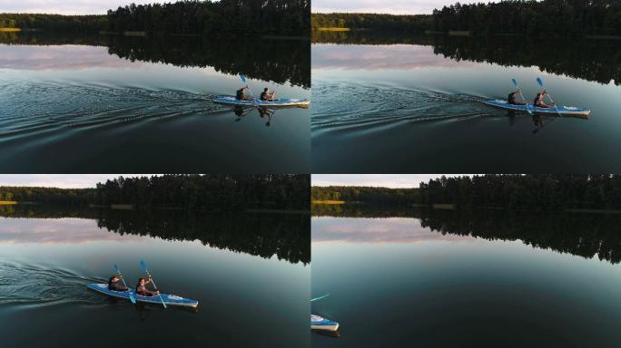 夏季放松活动。日落时划独木舟