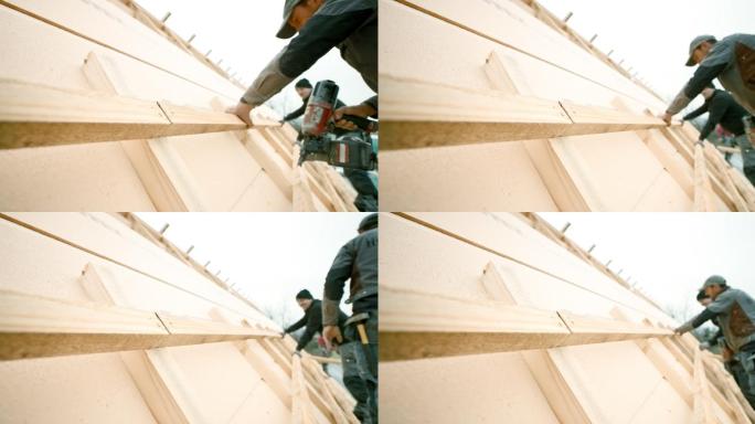 屋顶工人使用屋顶板条钉枪
