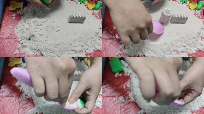 用塑料块打动砂玩耍