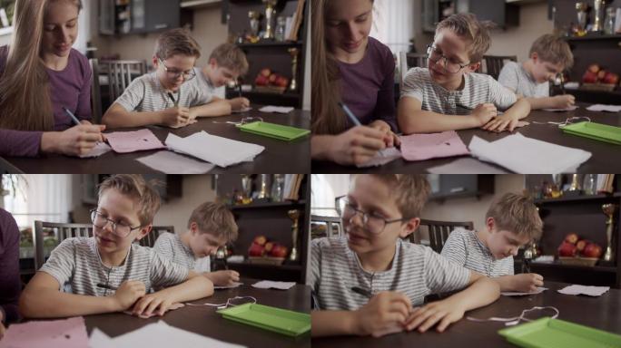 孩子们在手工制作的再生纸上写字