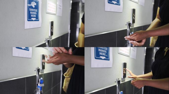 等待办公电梯时喷洒洗手液的女性