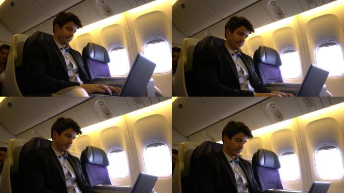 年轻的商务人士坐飞机去参加商务会议，用笔记本电脑工作