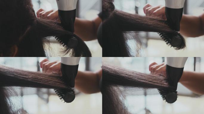 4k视频片段，一位面目全非的女性白天在沙龙里吹干头发