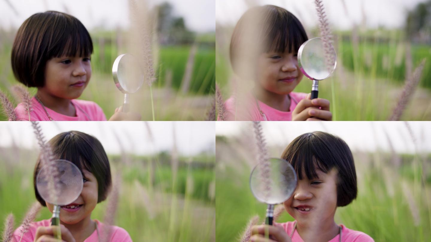 花田里用放大镜拍摄的小女孩肖像。
