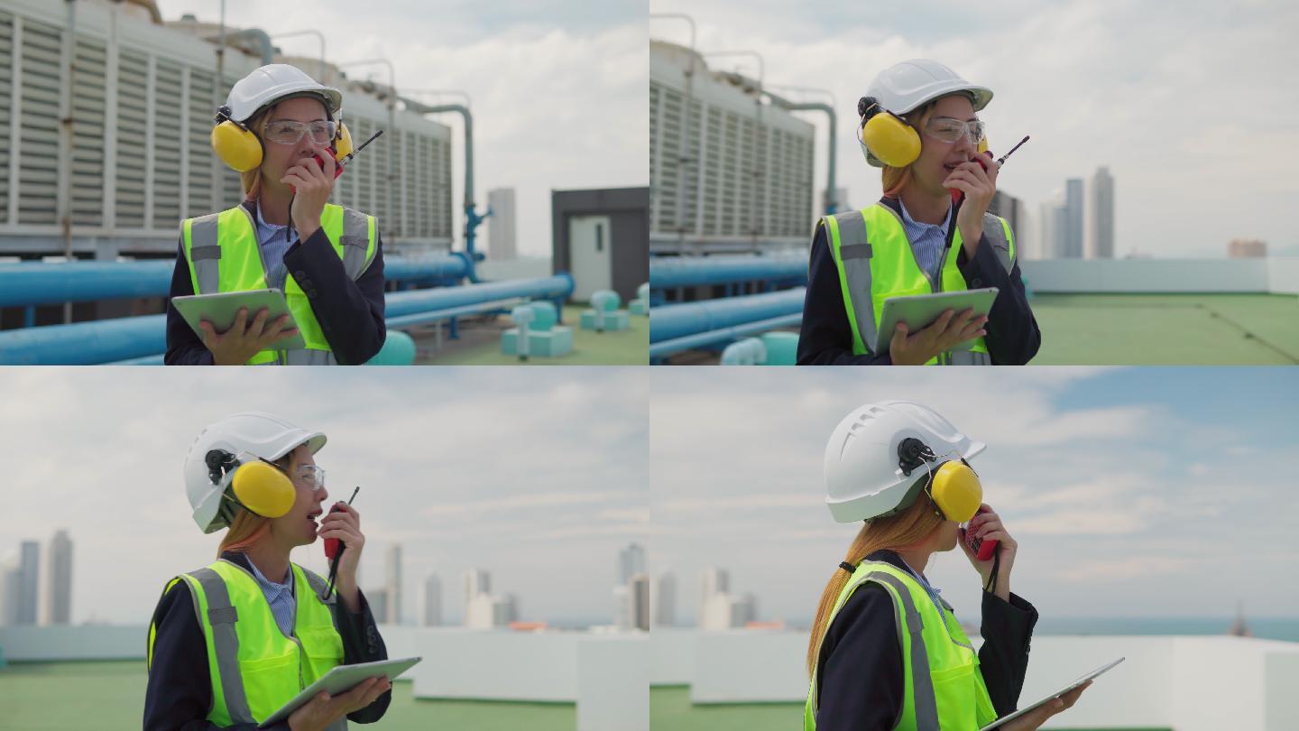 亚洲女性维护工程师检查大楼露台上的工作、大楼空调系统的维护