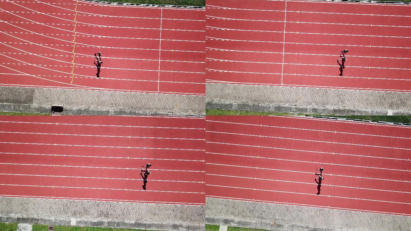 无人机视角体育亚裔华人情侣运动员上午在田径场跑步