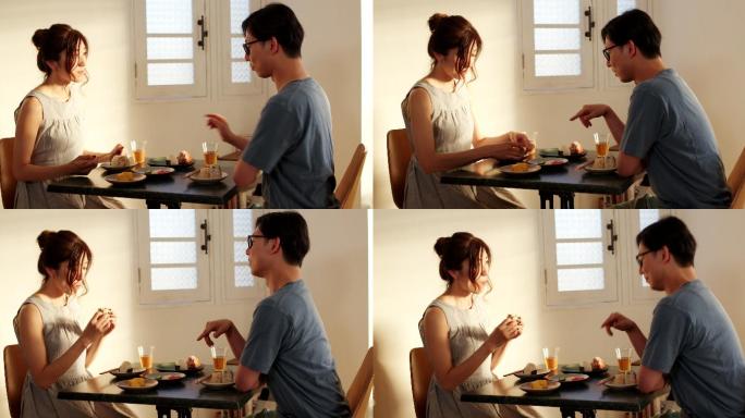 一对年轻夫妇在家里一起吃日本饭团的中镜头