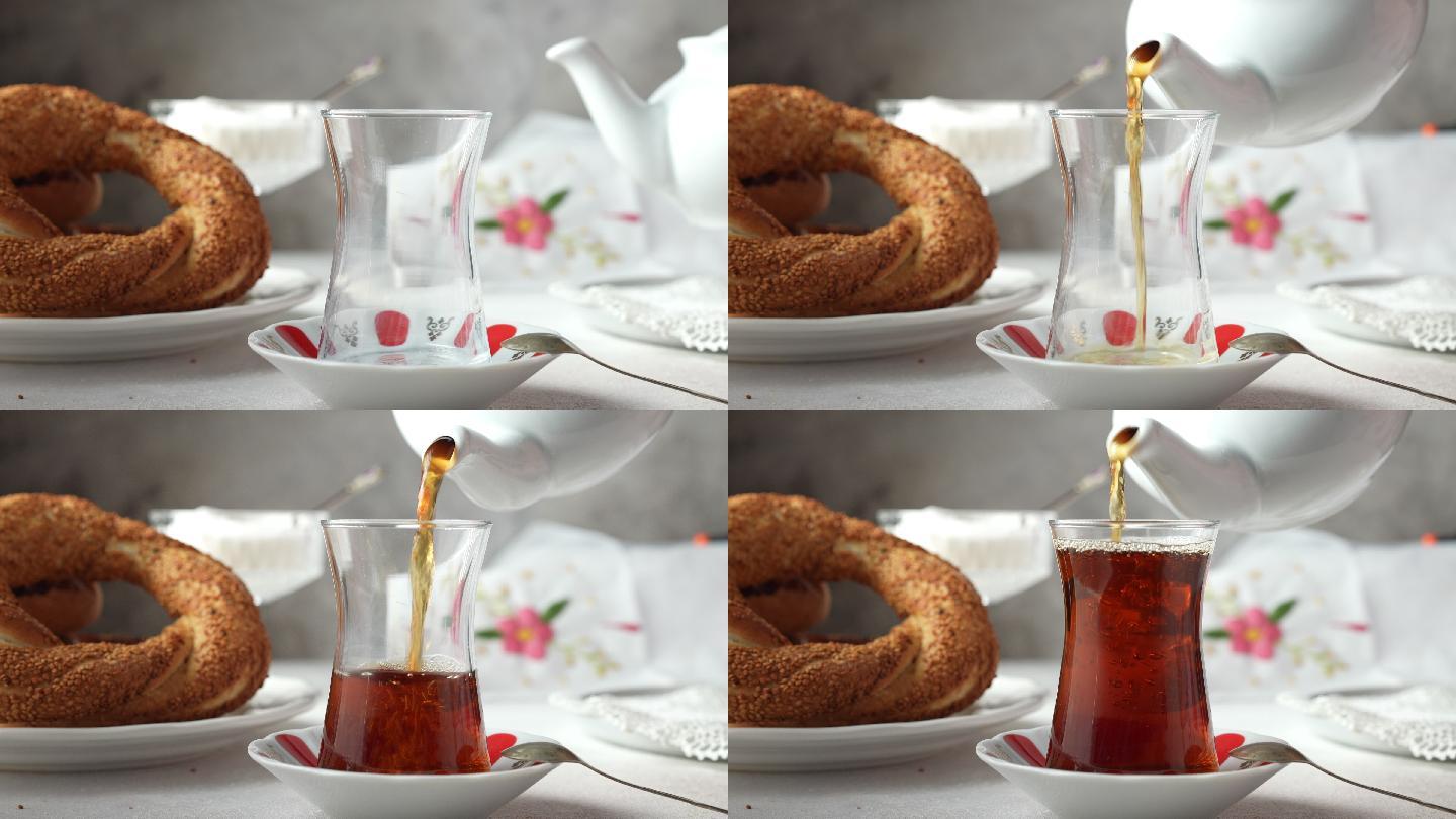 用瓷茶壶和土耳其百吉饼倒传统土耳其红茶