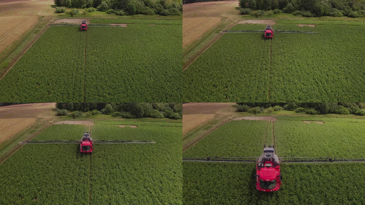 拖拉机在土豆地上行驶。施肥。无人机视角，靠近拖拉机