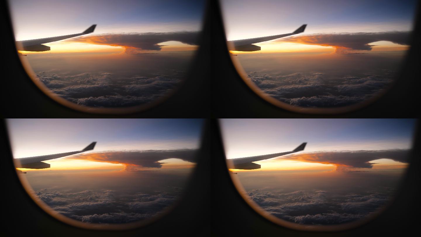 透过飞机窗口观看壮观的蘑菇云和日落