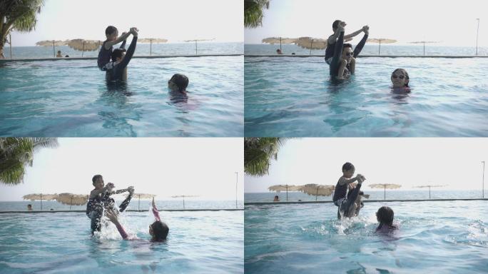 一家人带着一个小女儿和一个儿子一起去游泳池玩耍。