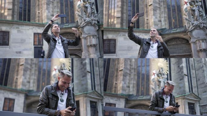 现代男性游客在维也纳圣斯蒂芬斯大教堂前用手机自拍