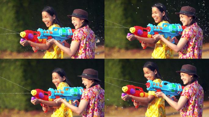 亚洲人在夏季四月的泼水节上使用水枪