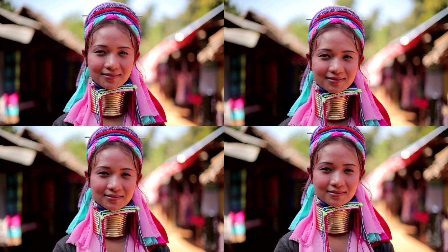一位脖子上戴着传统金属环的妇女在村里的一家织布厂工作
