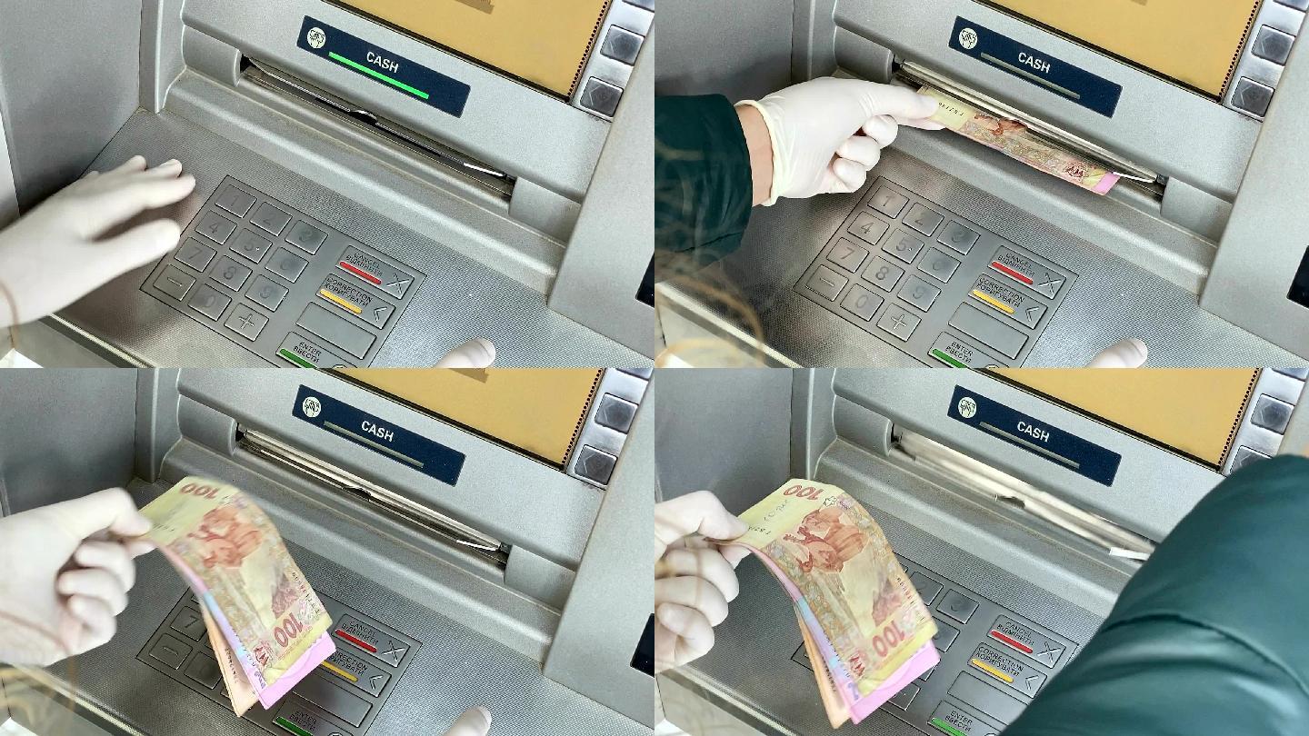 女性的手从自动取款机上取钱。