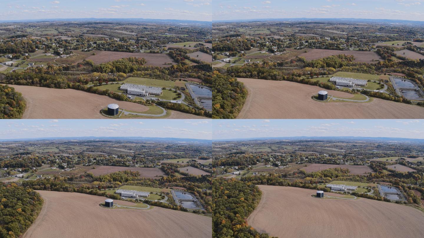 宾夕法尼亚州利海镇附近的农田，有森林、错落有致的田地、村庄和山间农场。具有向后摄影机运动的航空视频。