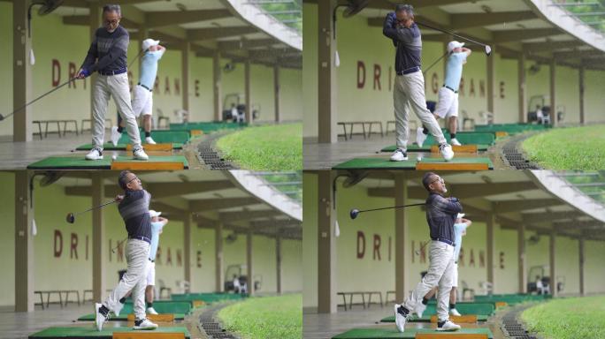 亚洲华人成年男子与其他高尔夫球手在练习场打高尔夫