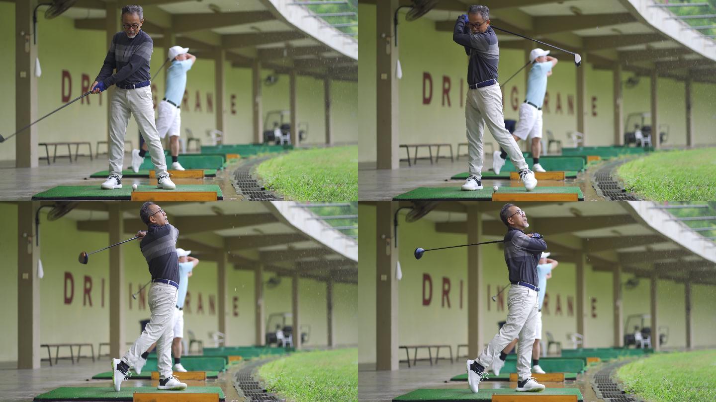 亚洲华人成年男子与其他高尔夫球手在练习场打高尔夫