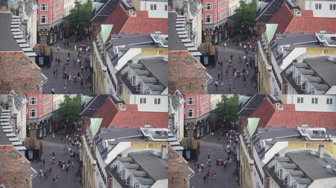 高角度视图：丹麦哥本哈根圆塔周围市场街道上的旅行者