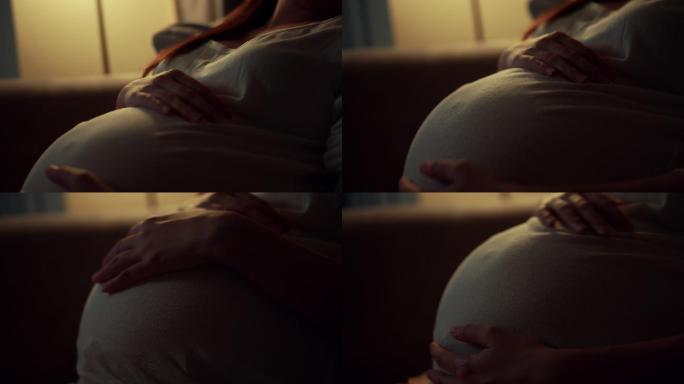 特写镜头沉思的孕妇对胎儿感到担忧，晚上情绪低落