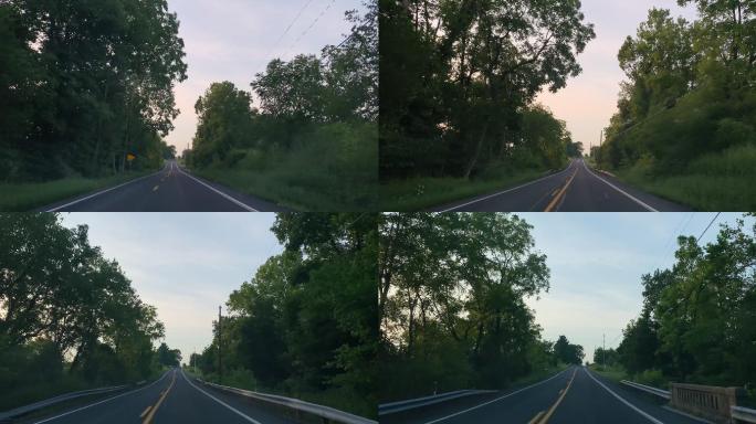 日落时分，在宾夕法尼亚州巴洛附近的一条绿树成荫的道路上开车