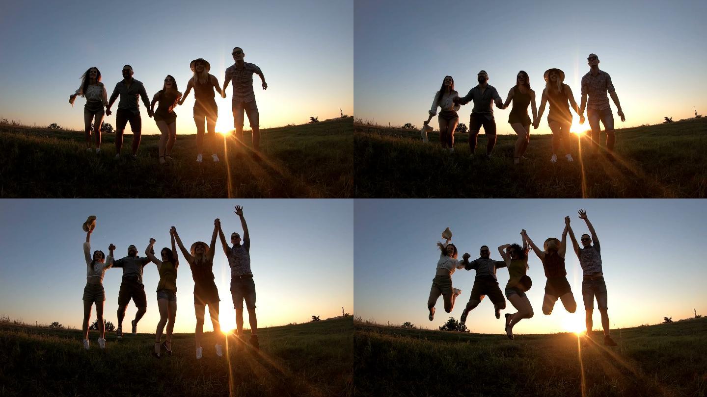 日落时分，朋友们一起在草地上跳跃
