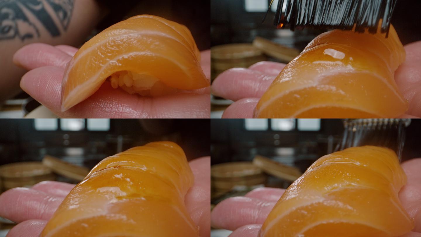 日本餐厅的日本厨师在日本料理上涂酱汁