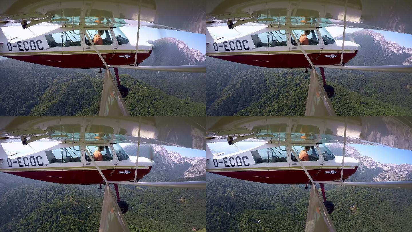 LD飞行员在阳光下驾驶轻型飞机在森林上空飞行