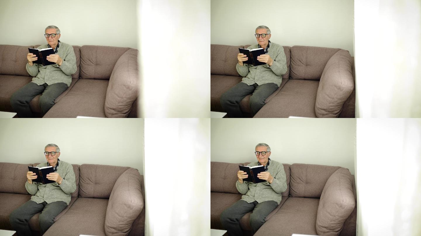 一个男人坐在客厅的沙发上看书。家庭老年生活。