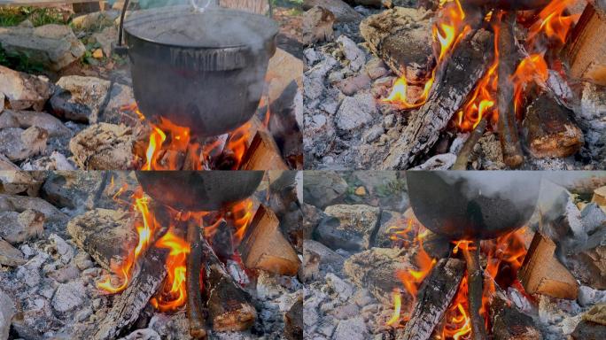 POV在铸铁锅中烹饪时照看营火的人