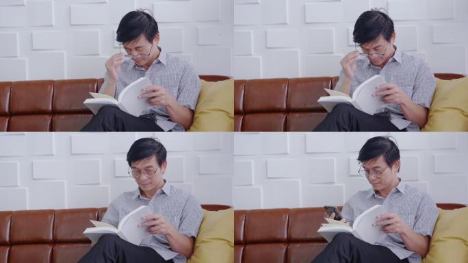 亚洲男子坐在那里看书眼睛疲劳