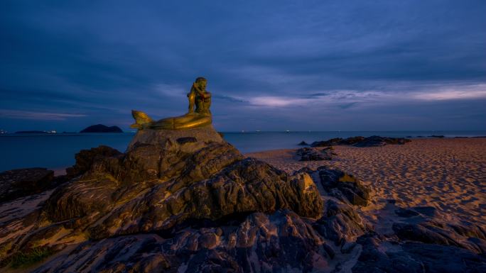 泰国宋克拉著名旅游景点美人鱼雕像的延时日出场景