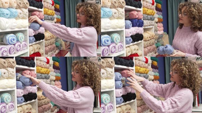 高加索女售货员在织物店货架上整理羊毛球