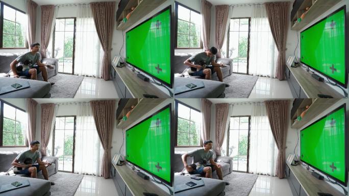 男性手拿电视，在家里的绿色屏幕上远程切换频道。